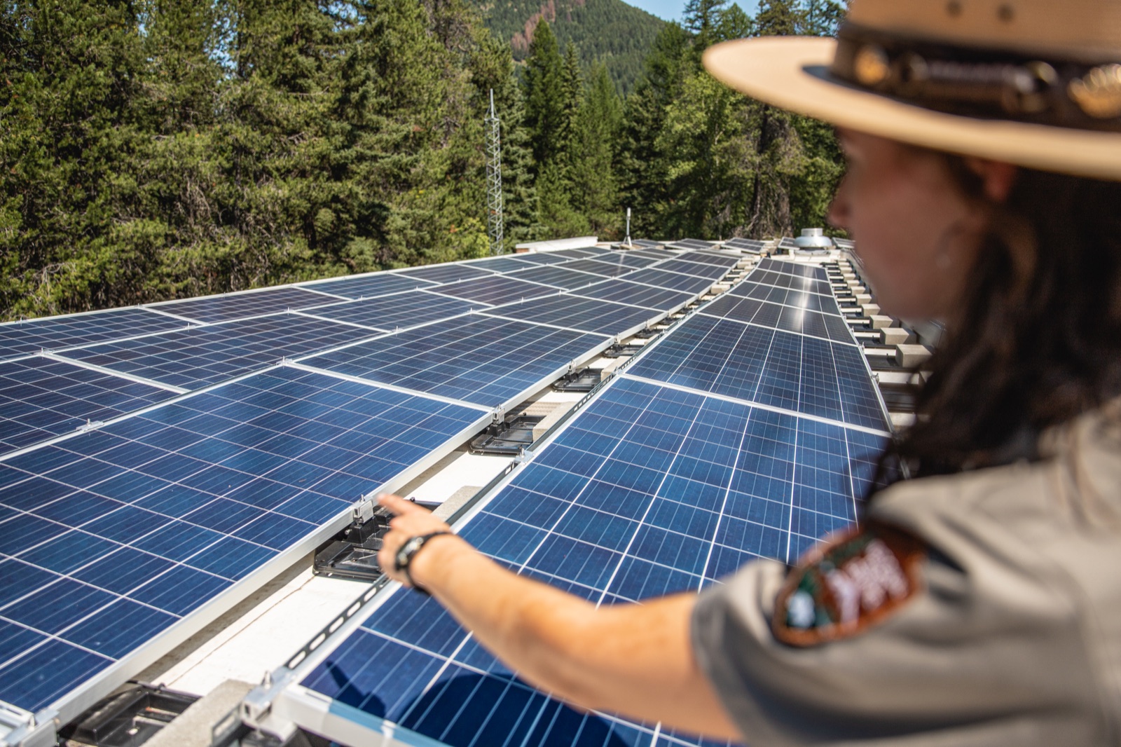 Technician inspecting rooftop solar panels